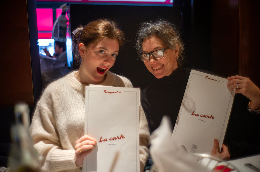Woman and teen girl holding a "La Carte" menu