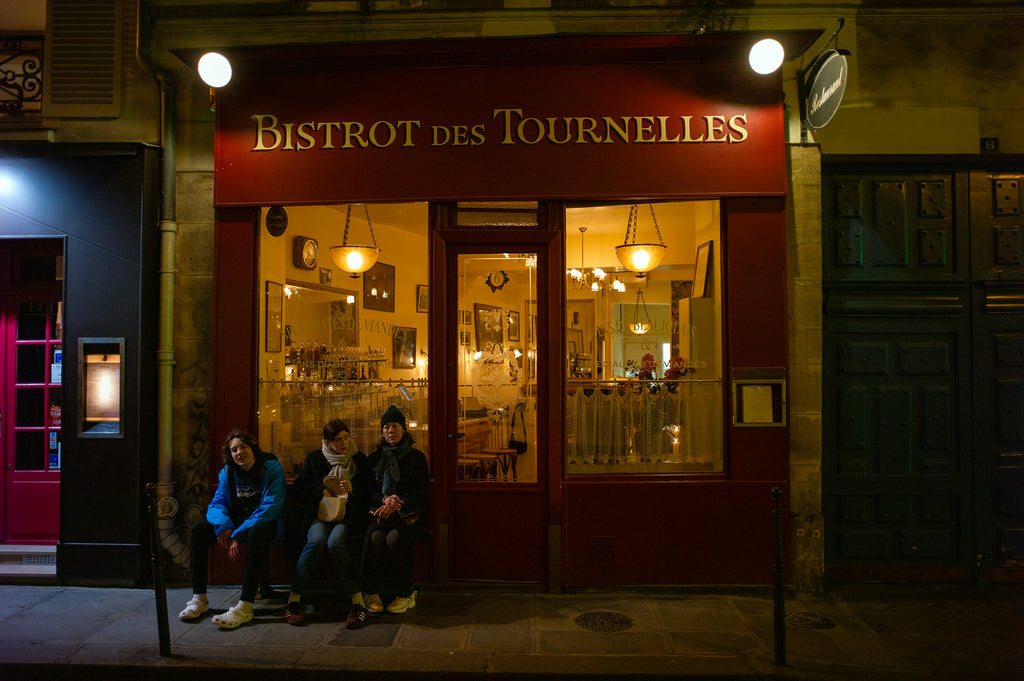 Mom and boy and girl waiting outside a Paris restaurant