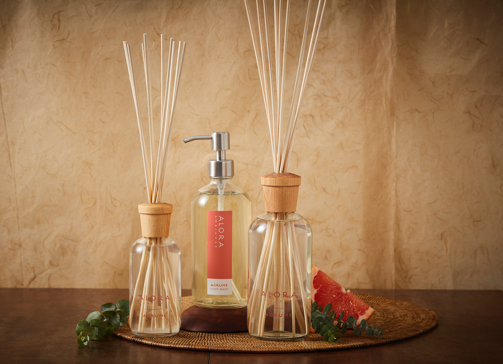 Two Agrume reed diffusers with an Agrume hand wash bottle