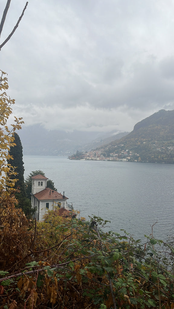 Italian homes surrounding a lake on a overcast day