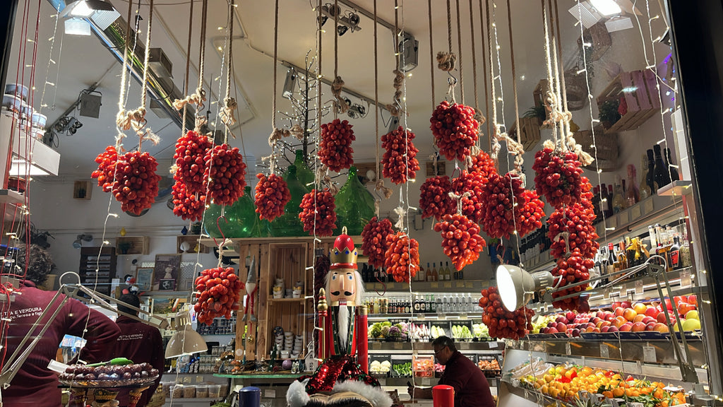 Clusters of tomatoes hanging on strings in a store