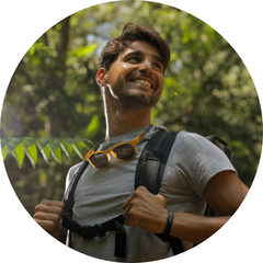 Man wearing Tram Slastik Sunglasses around neck while hiking