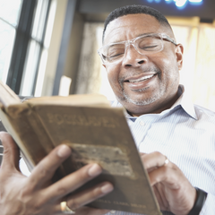 Man reading book with CliC readers on