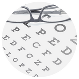 Eye chart with a pair of glasses sitting on it.