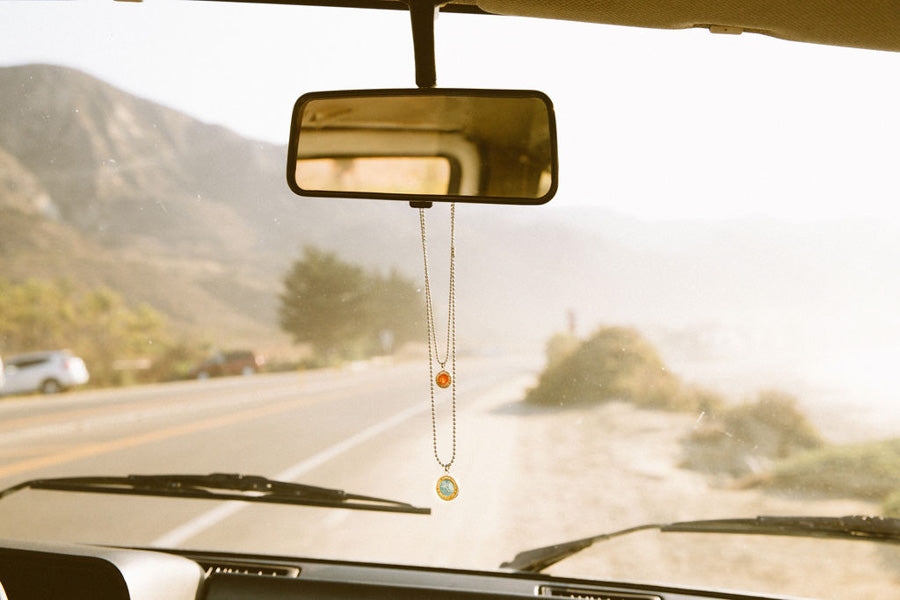 saint christopher necklaces hanging on rear view mirror