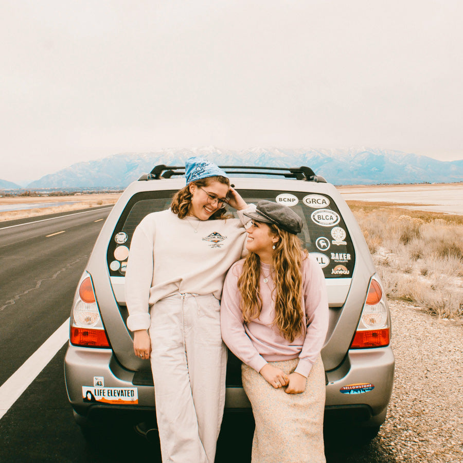 girls on road trip wearing st christopher surf medals