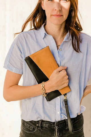Jen Lewis of Purse & Clutch holding the sustainable, ethical Connie Crossbody in Camel and Black | Wearwell