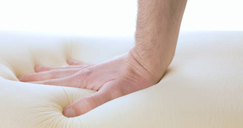 5 Reasons to Buy a Natural Latex Pillow - hand pressing down on latex pillow