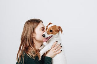 Girl hugging puppy