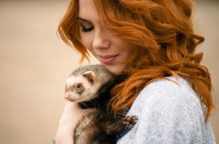 Red haired woman with ferret