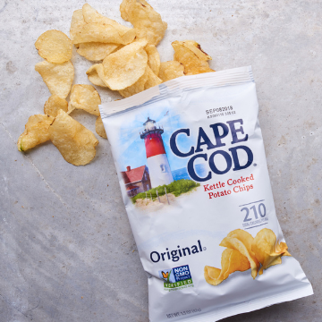 An open bag of Cape Cod kettle potato chips on a metal table