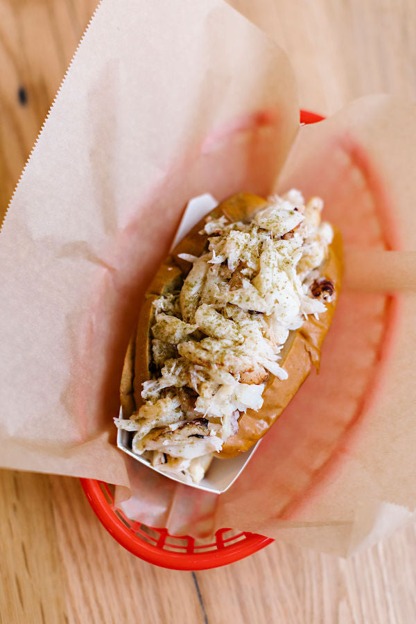 Dungeness Crab Roll in a red basket lined with wax paper