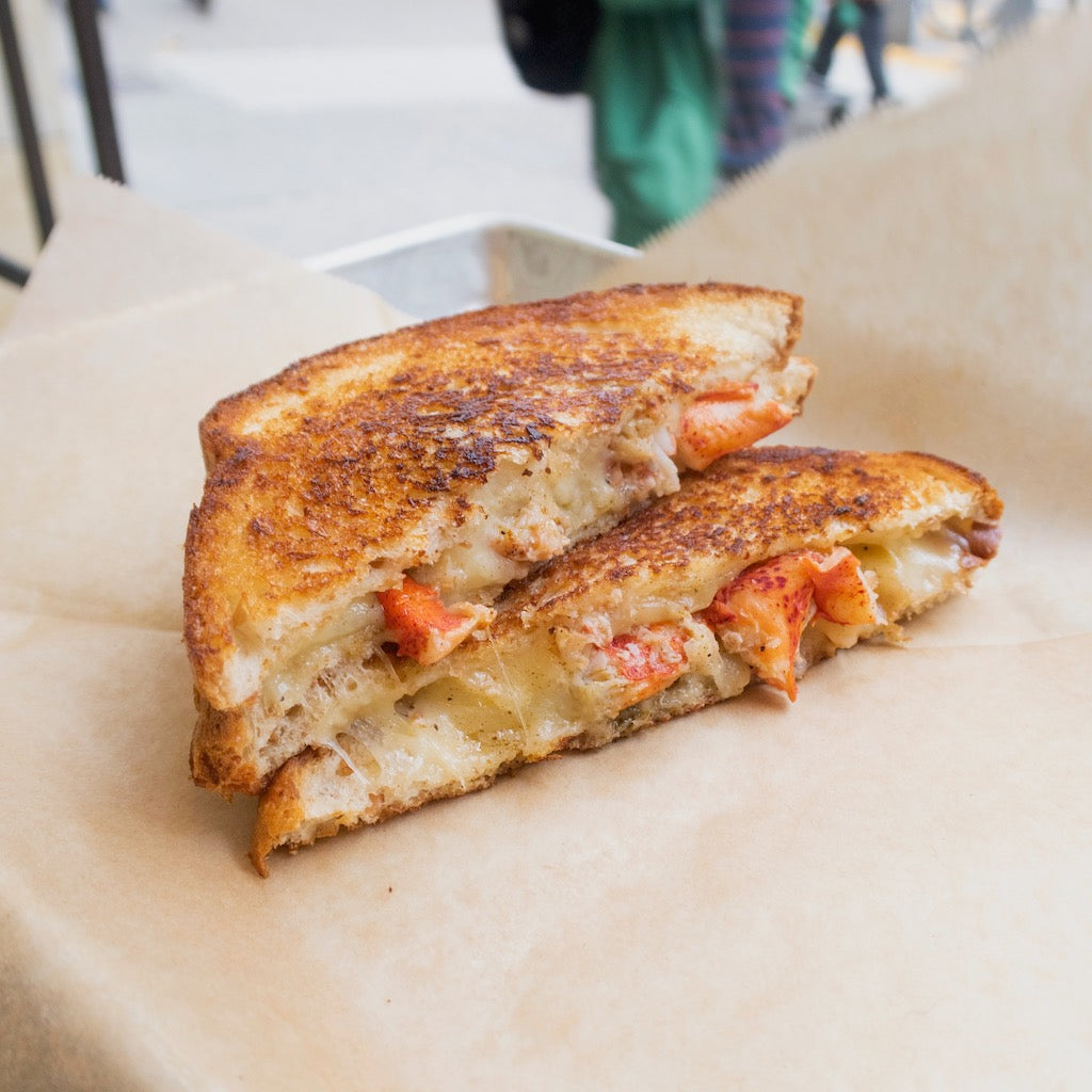 lobster grilled cheese on a tray lined with parchment paper