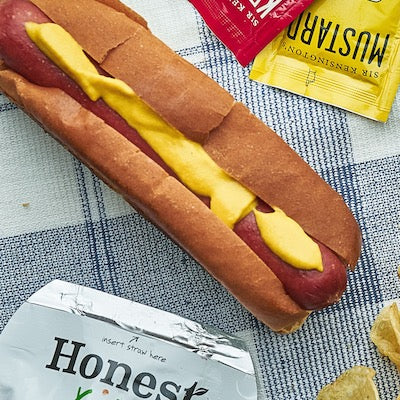 Hot dog on a white and black tablecloth