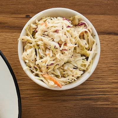 Poppyseed coleslaw in a white dish