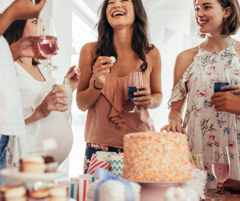 Women at a baby shower laughing