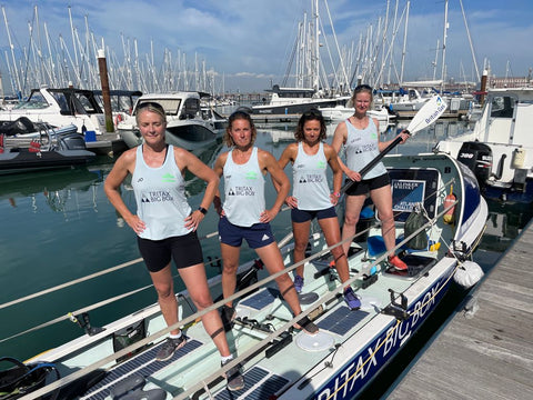 The Mothership team standing in the rowing boat