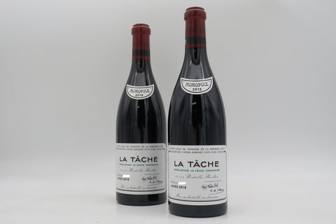 Two wine bottles on display in front of a white background