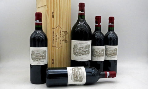 A group of wine bottles and a wooden box