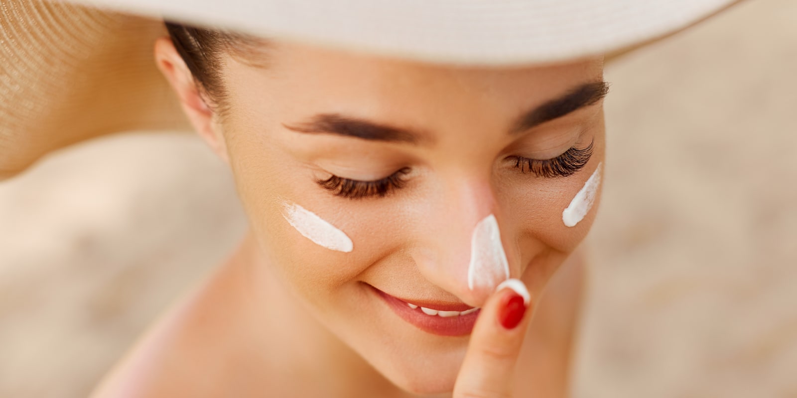 Woman with sun cream on her face