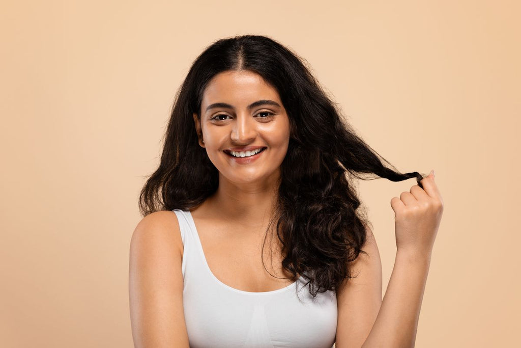 woman touching her hair and smiling