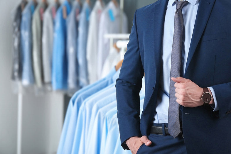 businessman and a rack of clean clothes