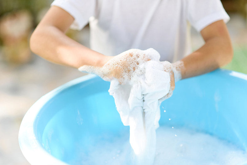 hand washing a white shirt