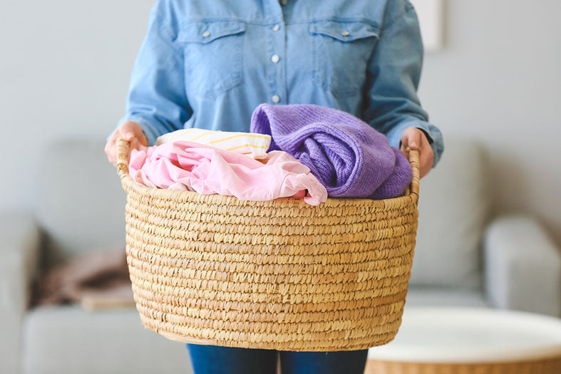 holding basket of laundry