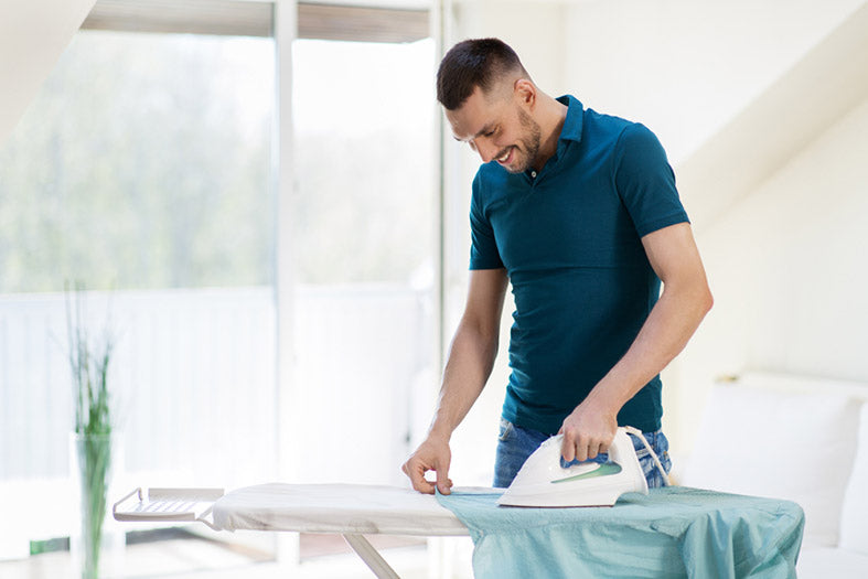 man ironing a shirt