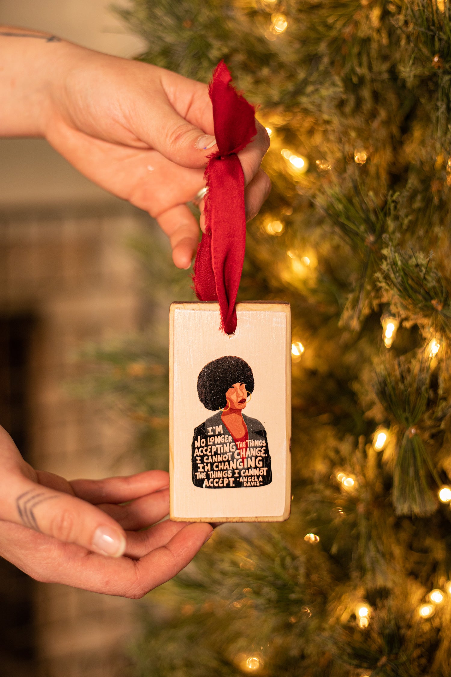 Wood Christmas ornament featuring illustration and quote of activist and feminist Angela Davis