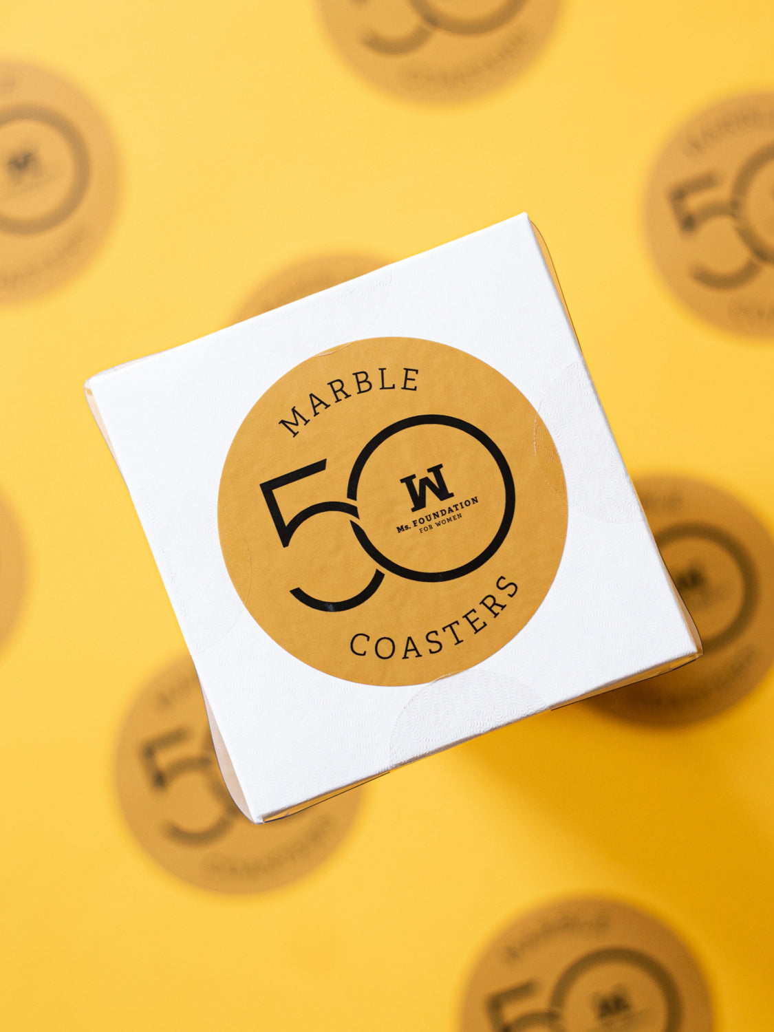 50th anniversary sticker on white box with gold background