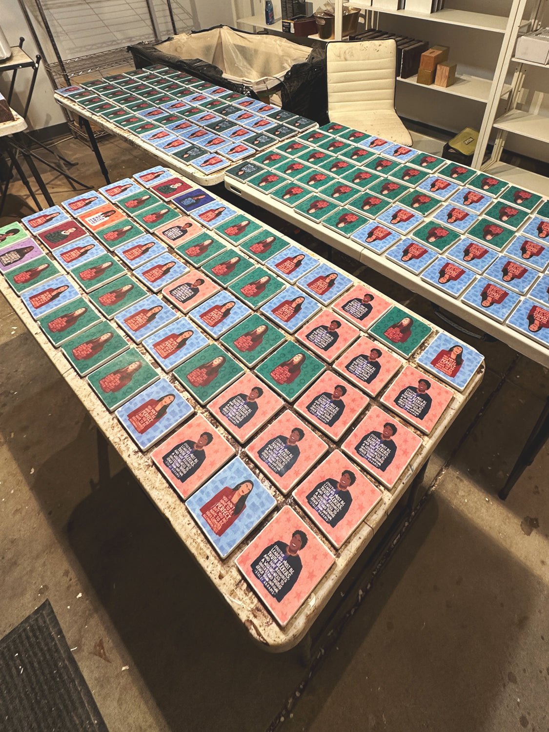 Feminist illustration marble coasters on tables in workshop