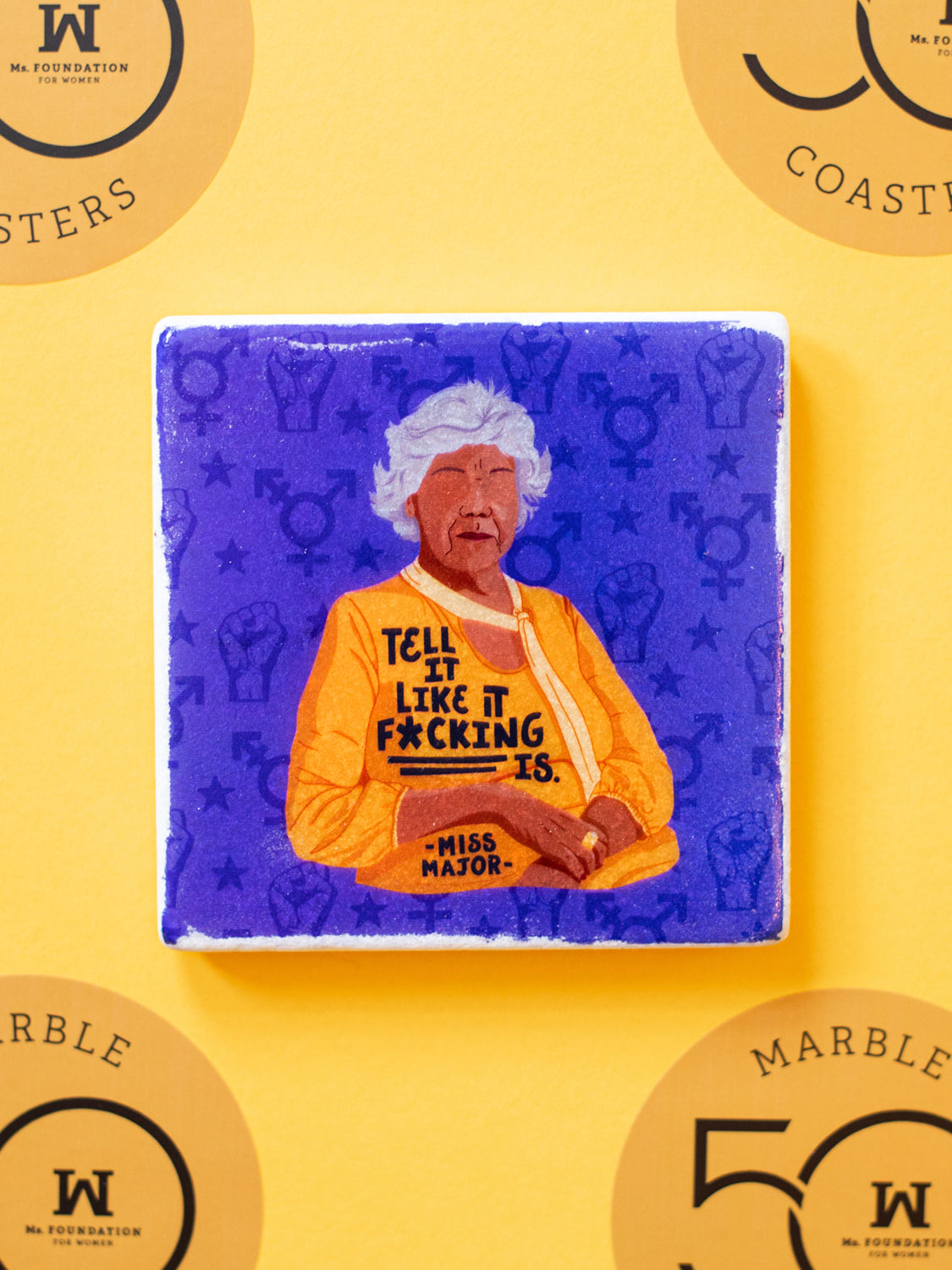 Marble coaster with illustration of black transgender activist Miss Major that says "Tell it like it f*cking is."