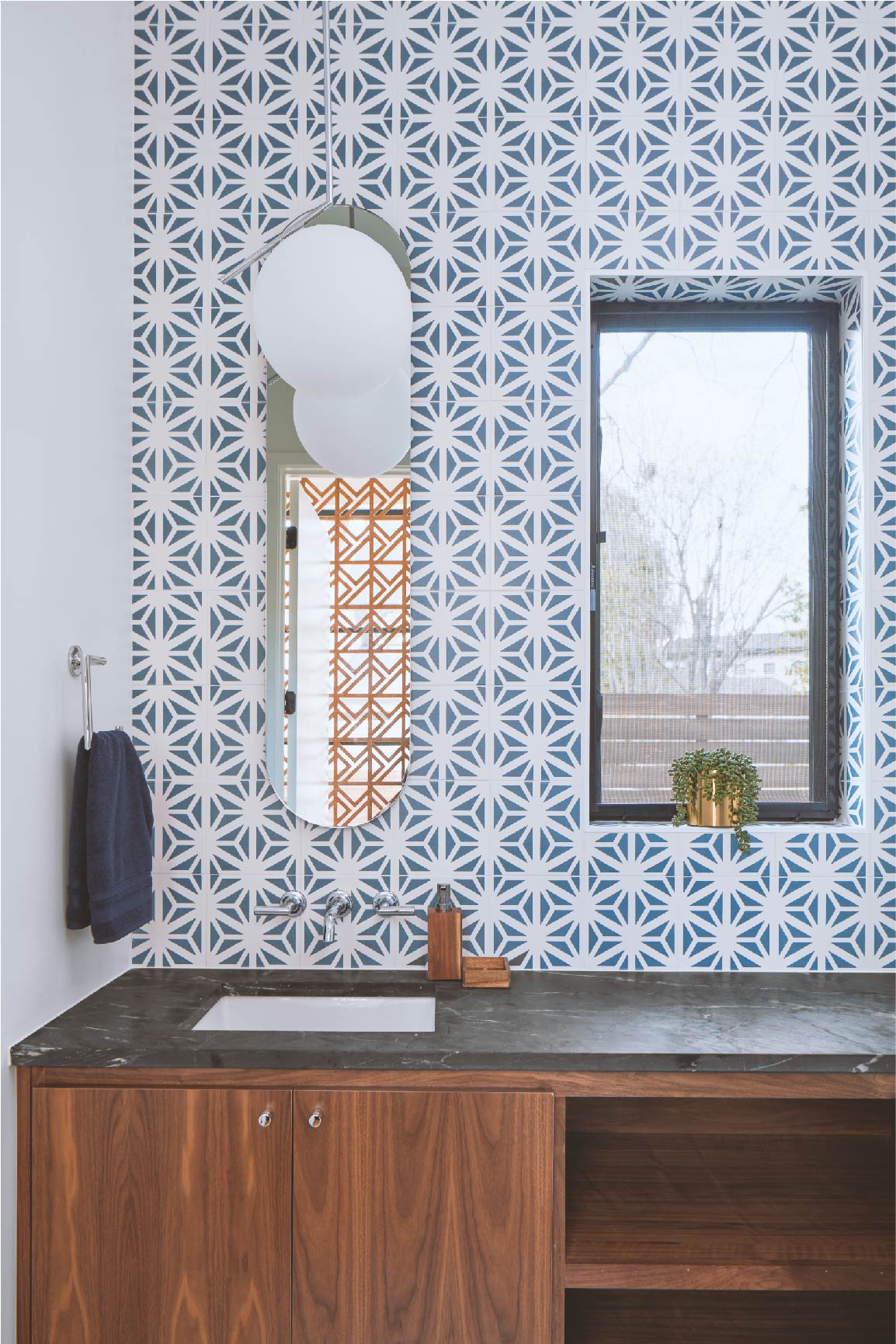 Bathroom and sink wall with blue tiles backsplash