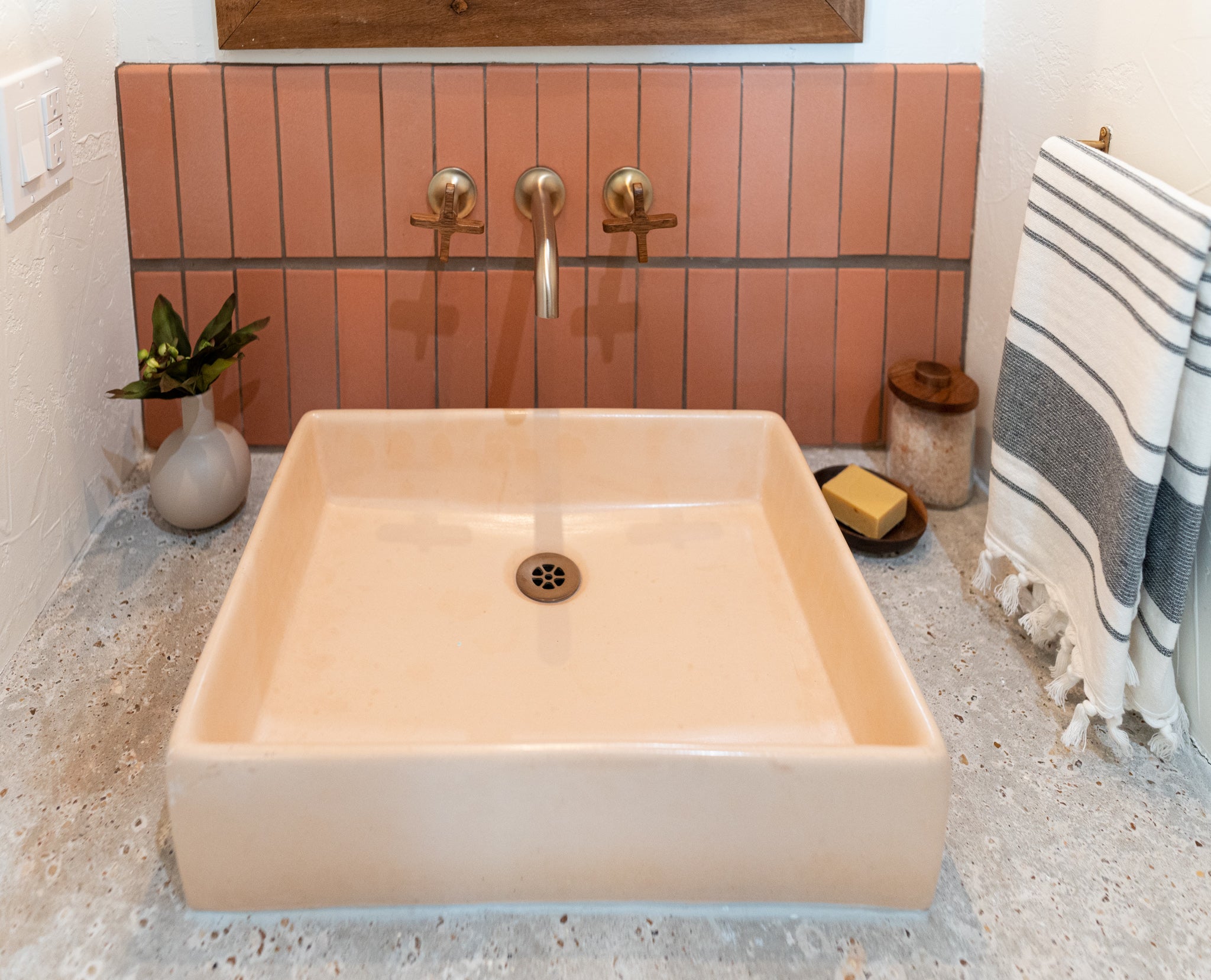 Bathroom sink with red tile and pink sink clay imports