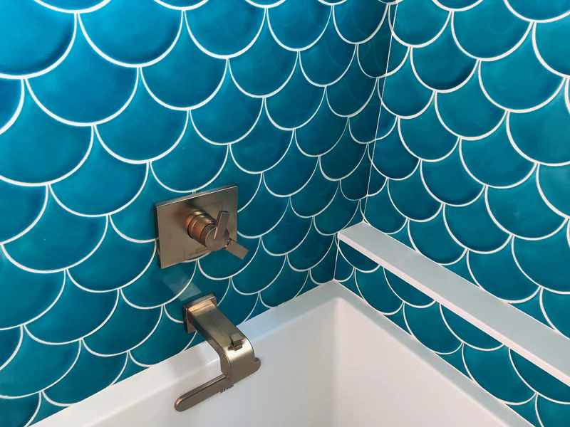 Bathroom and shower design with blue fish scale tiles