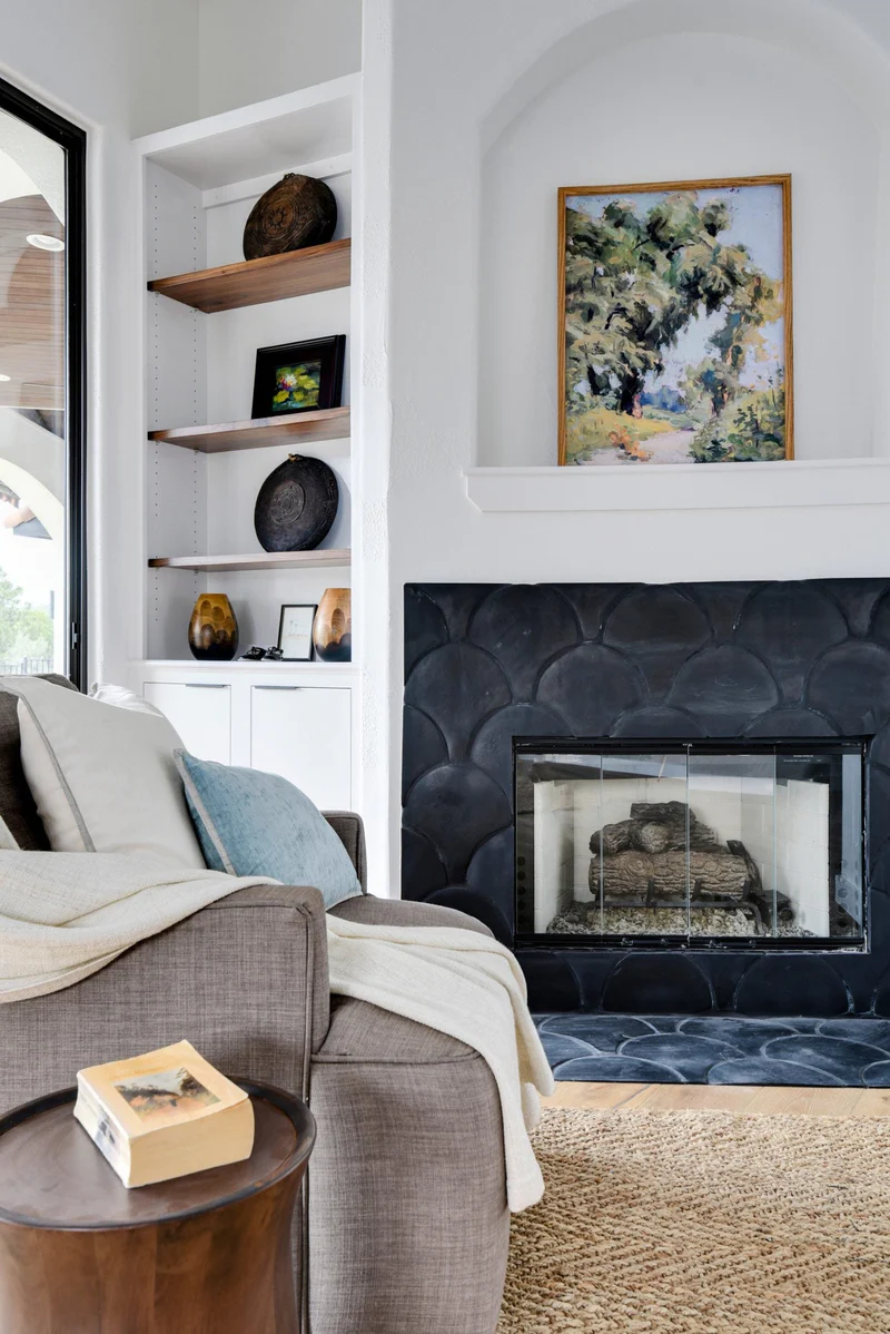 Modern fireplace design with black fish scale tiles by Clay Imports