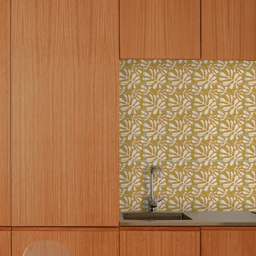 Kitchen backsplash with yellow and white floral patterned tiles