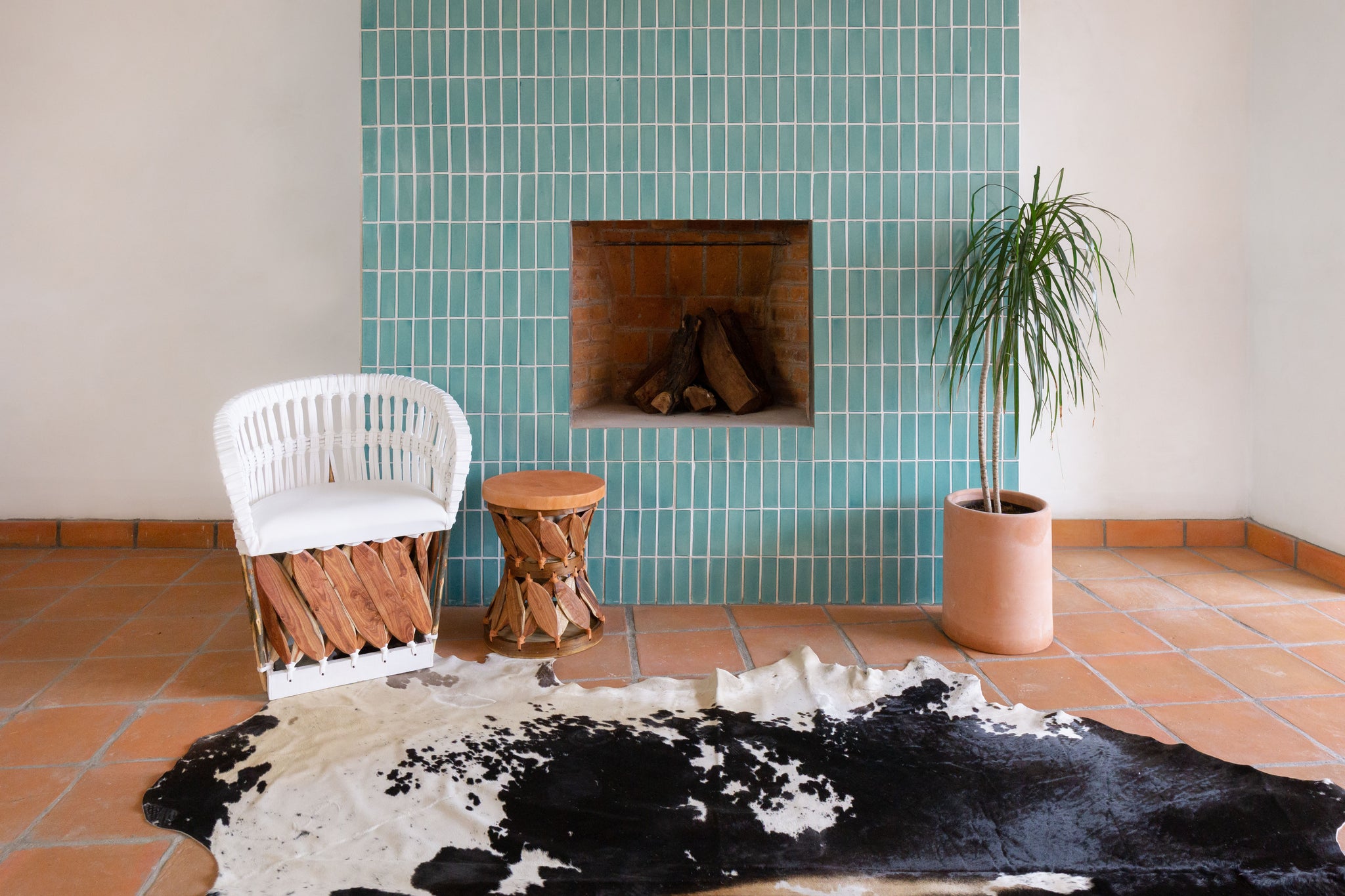 Equipal chair in front of subway blue tiled fireplace