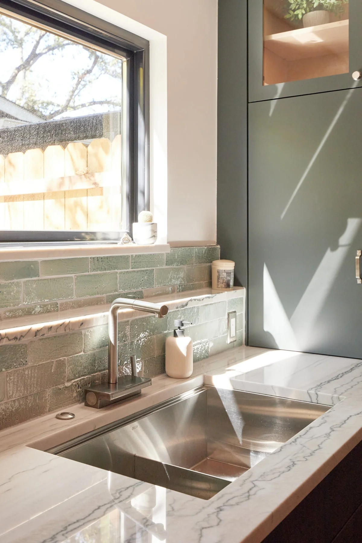 Kitchen backsplash with light green tiles