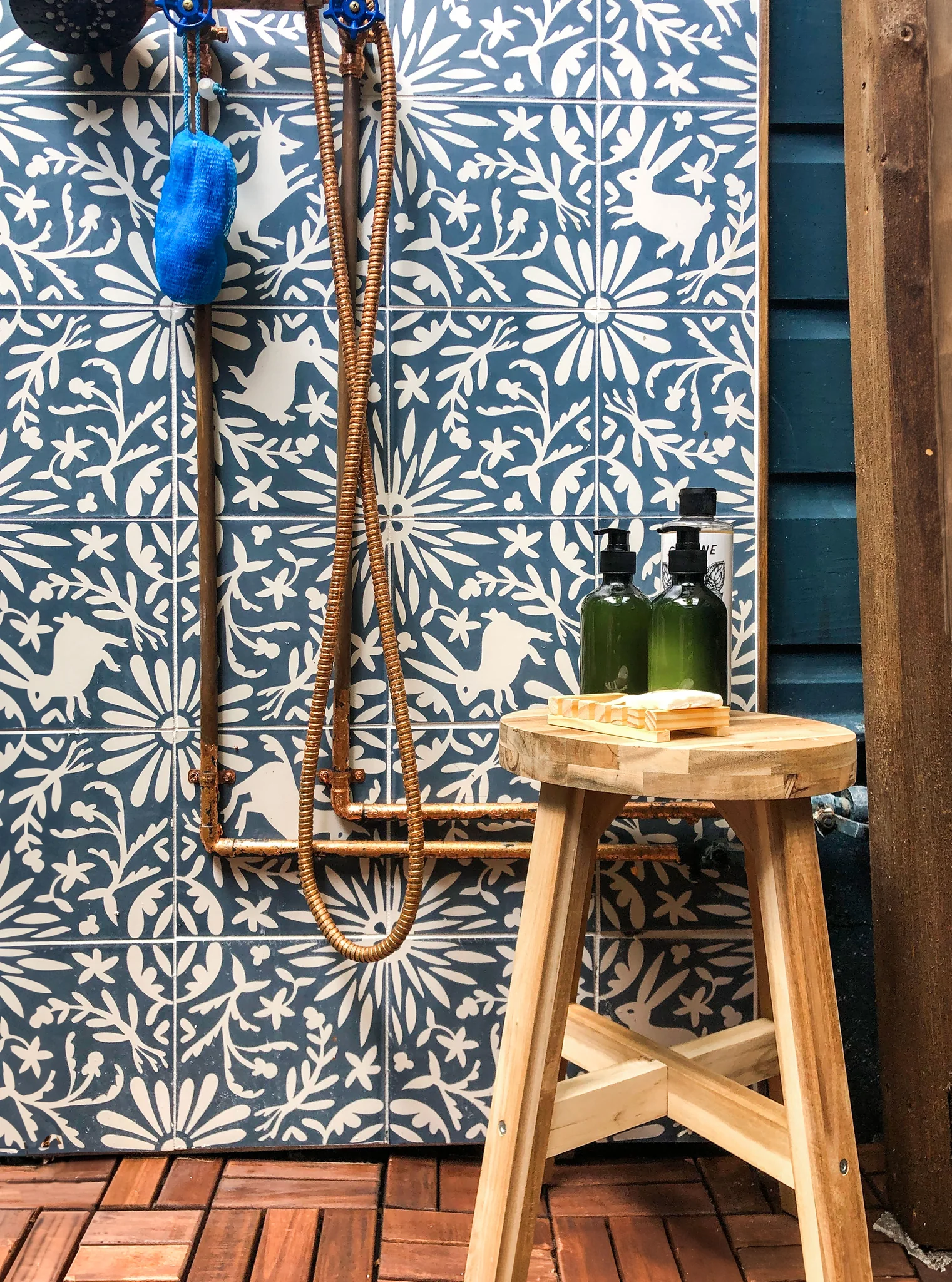 Outdoor copper shower with blue and white tiles