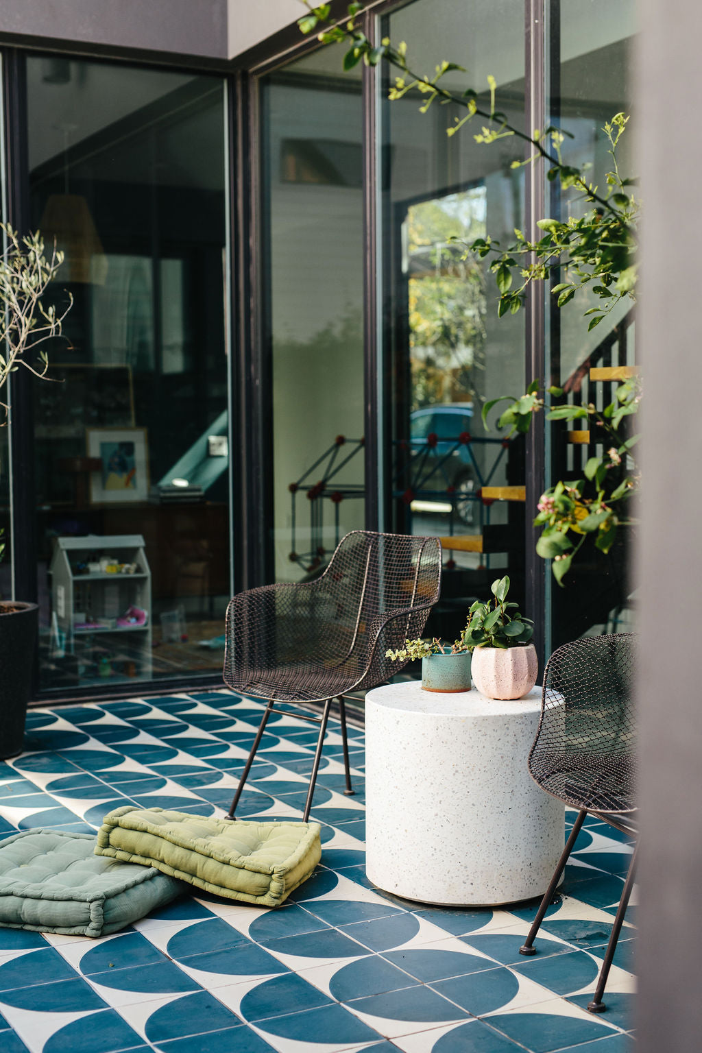 Patio with large windows and blue pattern clay tile clay imports