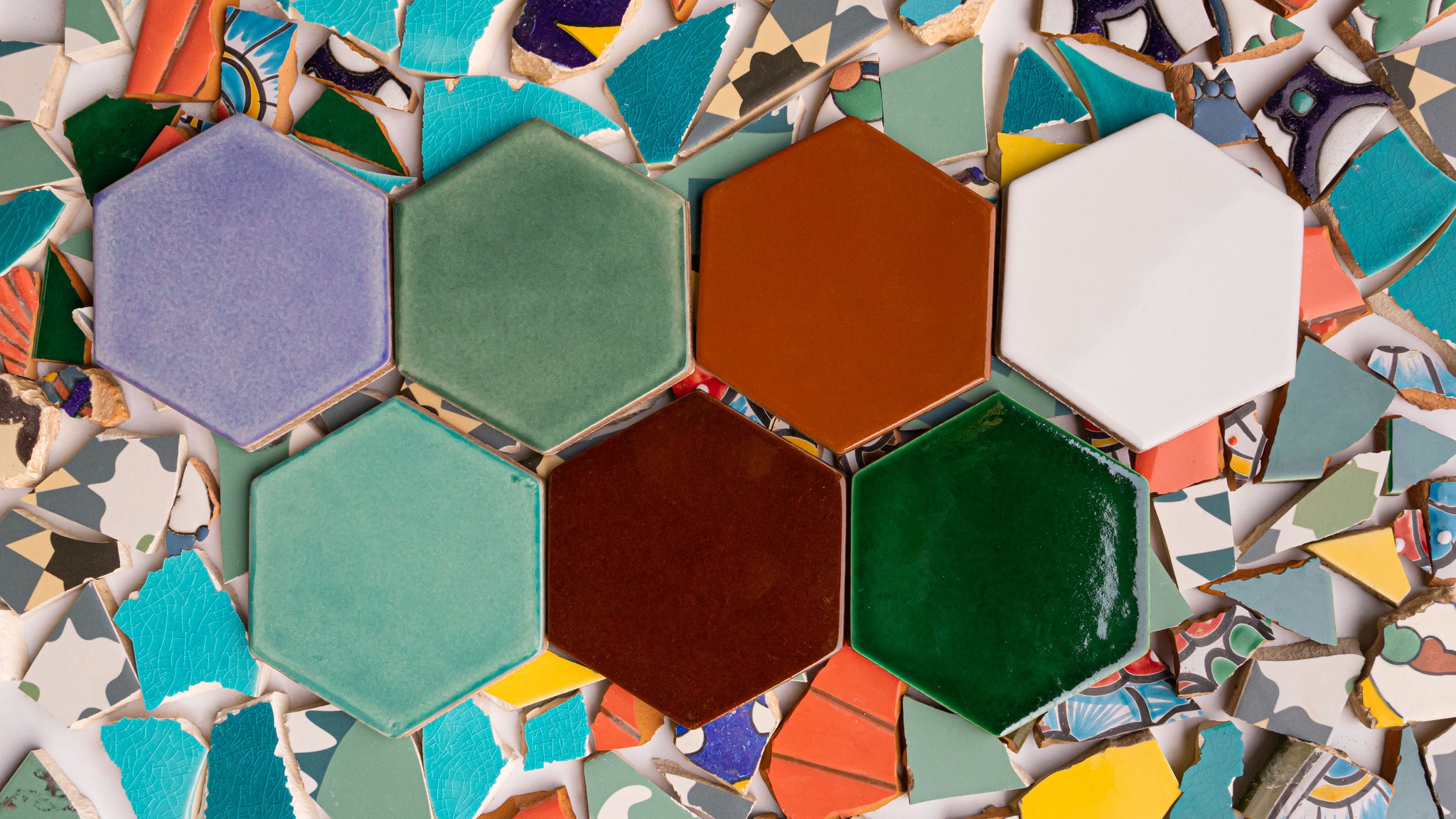 Hexagon shaped colored tile with tile scraps used to make the recycled tile by Clay Imports