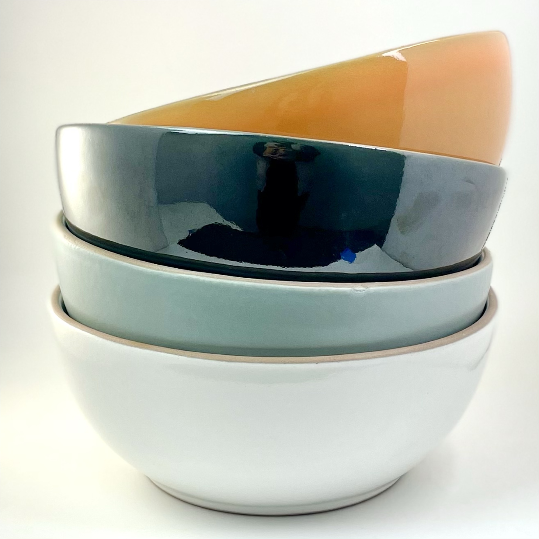 Poco Clay ceramic bowls with white, blue, and orange glaze clay imports