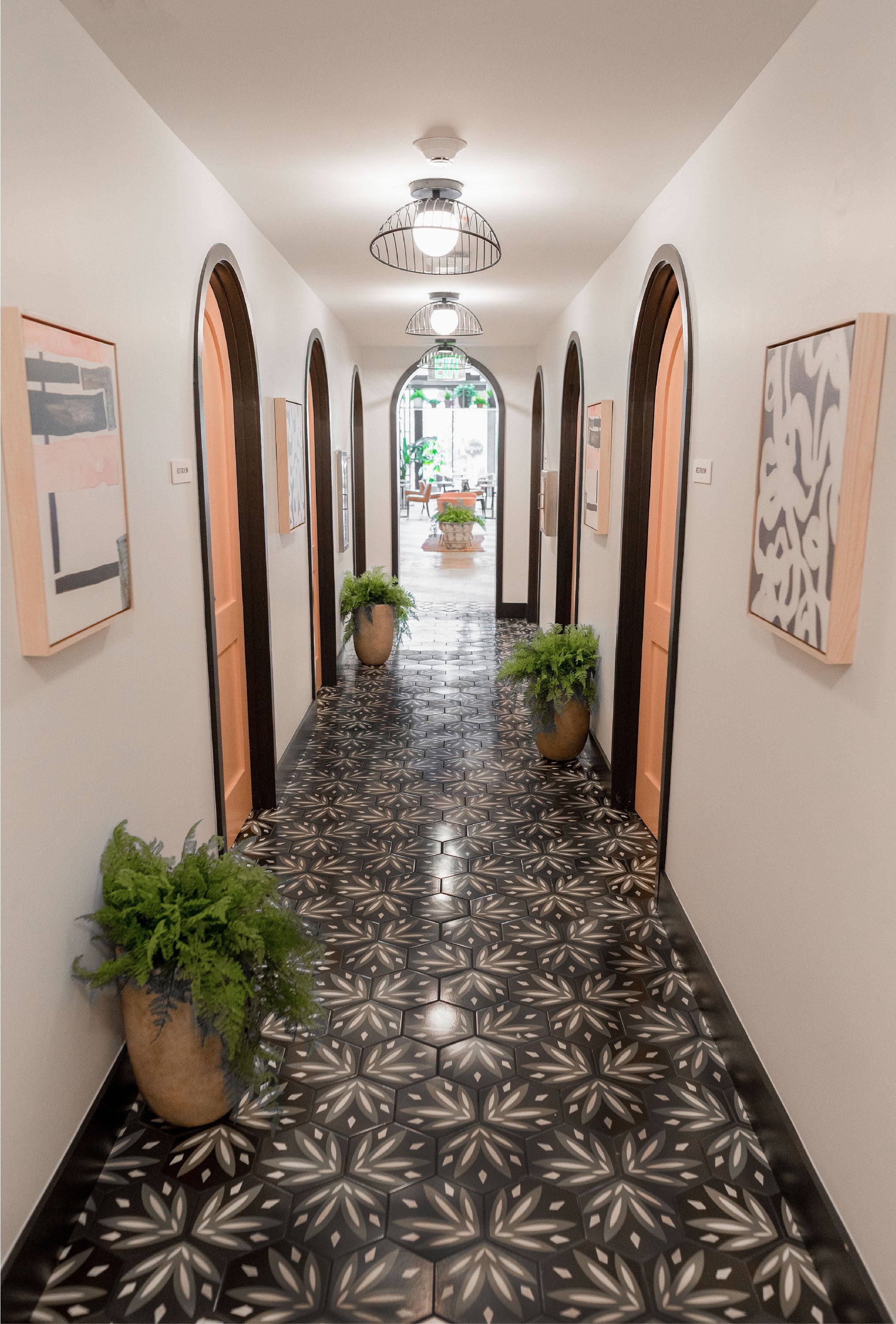 Hallway with pattern tile floor by clay imports