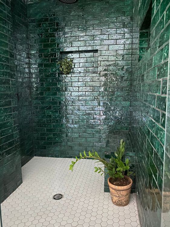 Shower niche with green subway tiles