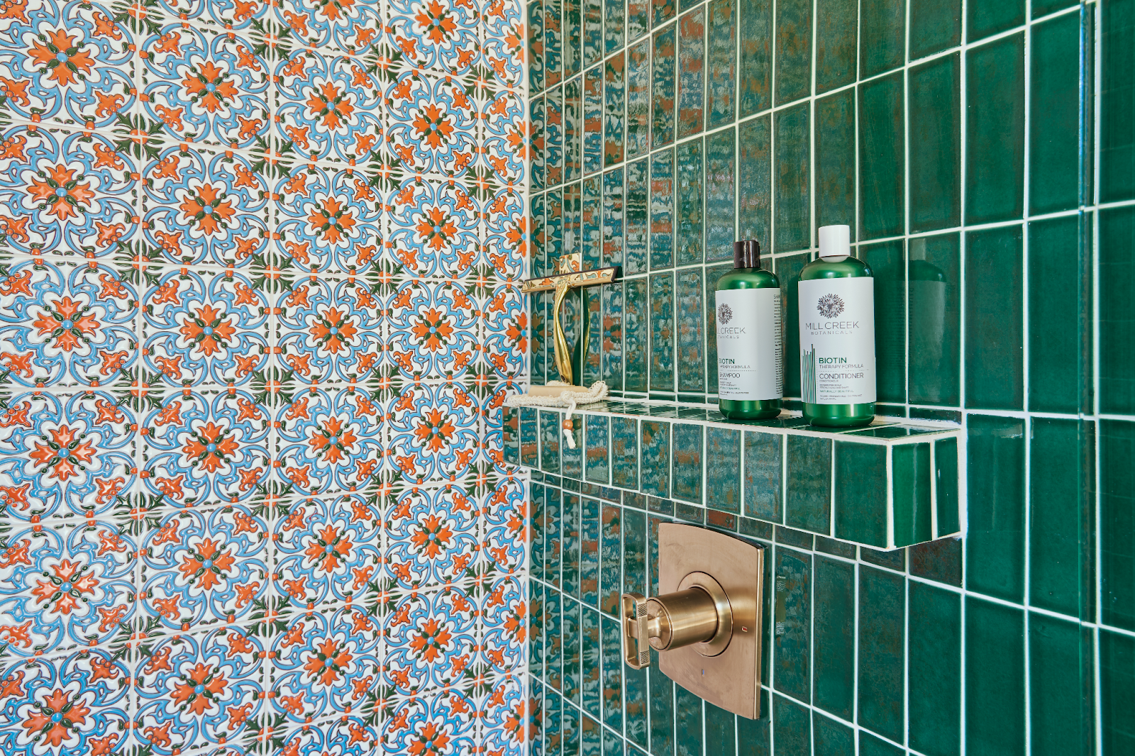 Modern bathroom design with green and hand painted tiles