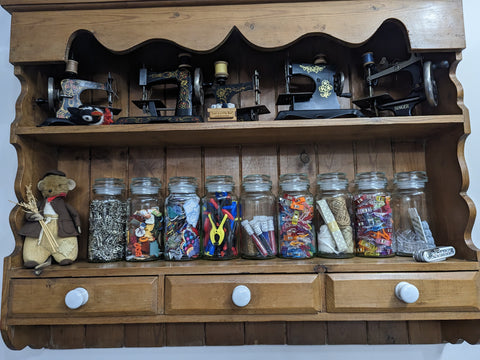 picture showing coffee jars on wooden shelves storing bits and bobs 