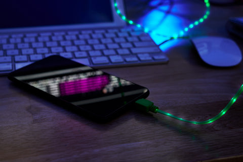 glowing-charging-cable-smartphone-lying-office-table-darkness