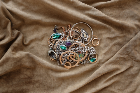 jewelry laid on bedsheet